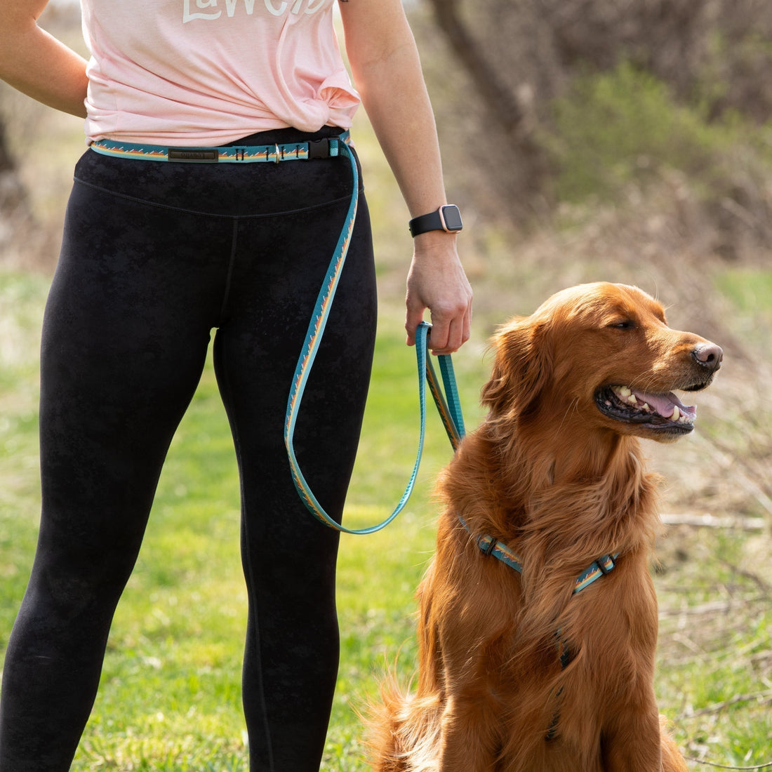 Dog mom hiking with her pup using Luwello’s hands-free adjustable dog leash with accessory loop